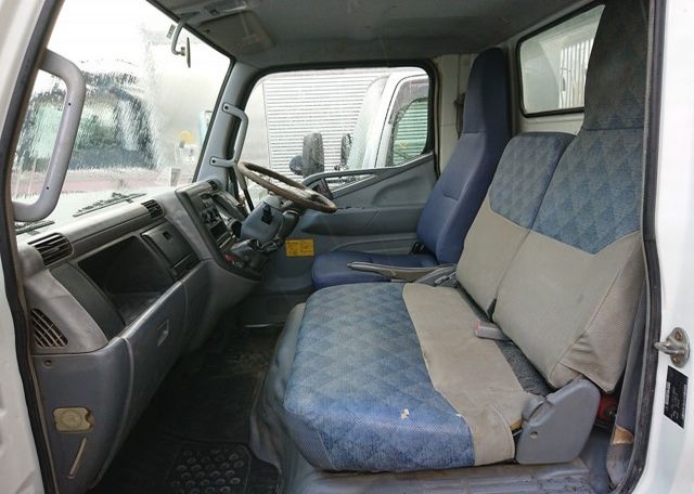 2006 Mitsubishi Canter Dump Truck. Cab interior from passenger's side. Three seat cab