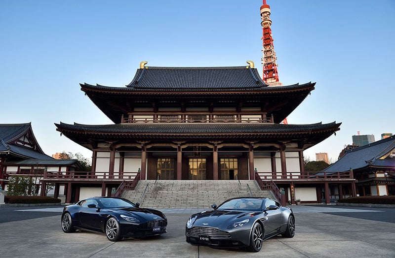 Aston Martin is Huge in Japan : Two Aston Martins with Zojo-ji Temple and Tokyo Tower in the background