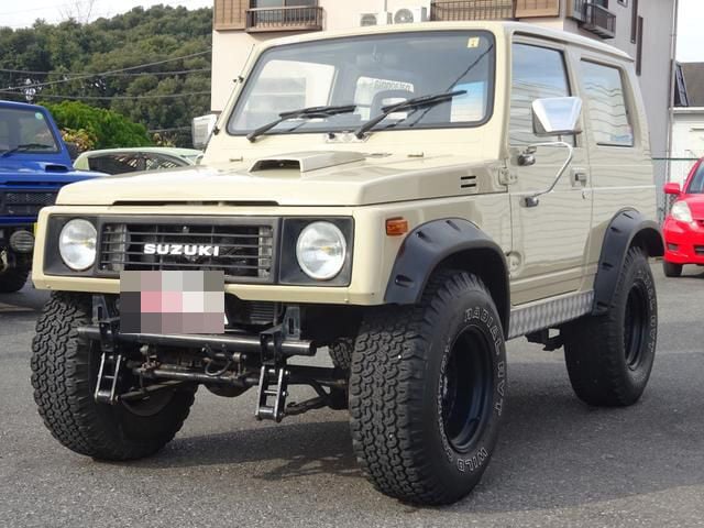Front view of lifted sand colored Suzuki Jimny